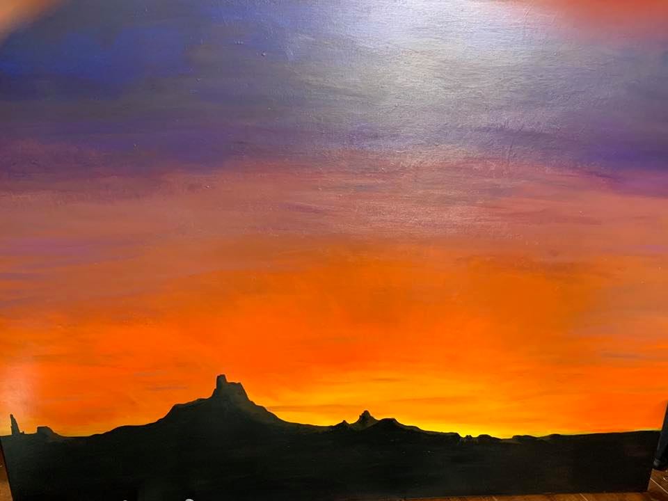 Arizona Sunset — desert buttes silhouetted at dusk